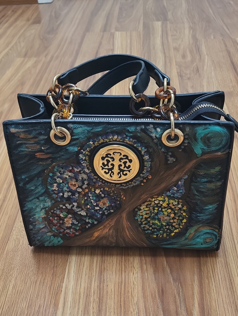 Black Shoulder Bag with Teal Floral Artwork and Gold Medallion